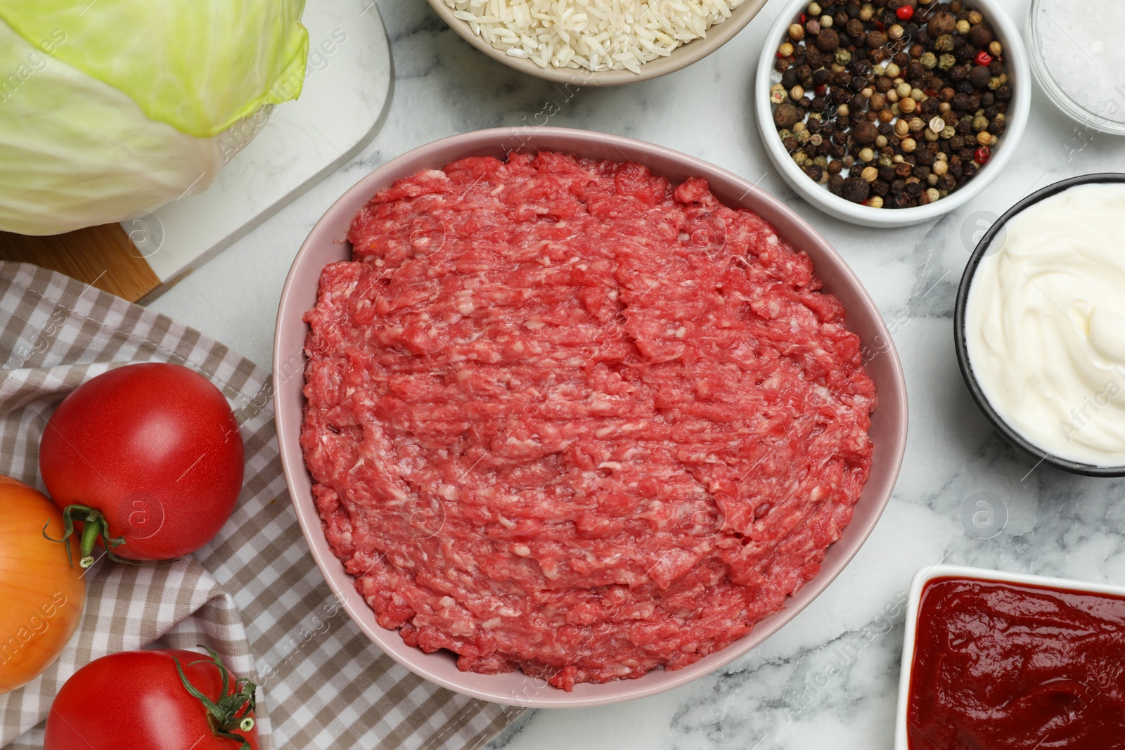 Photo of Set of ingredients for preparing stuffed cabbage rolls on white marble table, flat lay