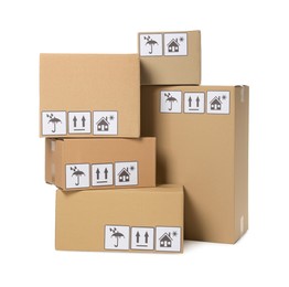 Photo of Many closed cardboard boxes with packaging symbols on white background. Delivery service