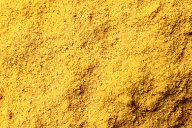 Photo of Dry curry powder as background, top view