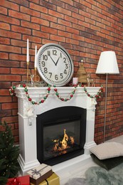 Photo of Modern fireplace decorated for Christmas in living room
