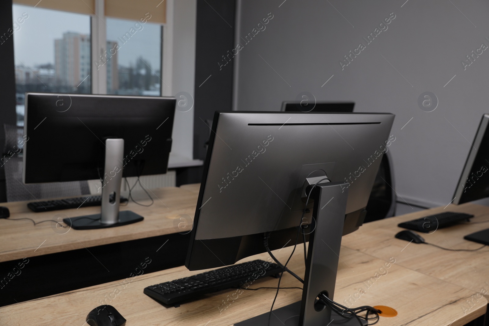 Photo of Many modern computers in open space office