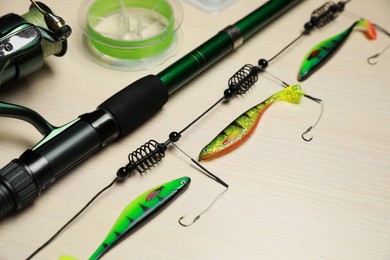 Fishing tackle on light wooden background, closeup