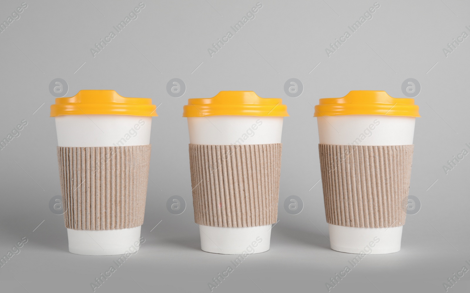 Photo of Carton cups on grey background. Mock up for design