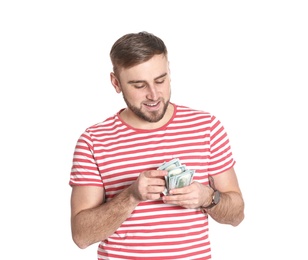 Portrait of young man counting money banknotes on white background