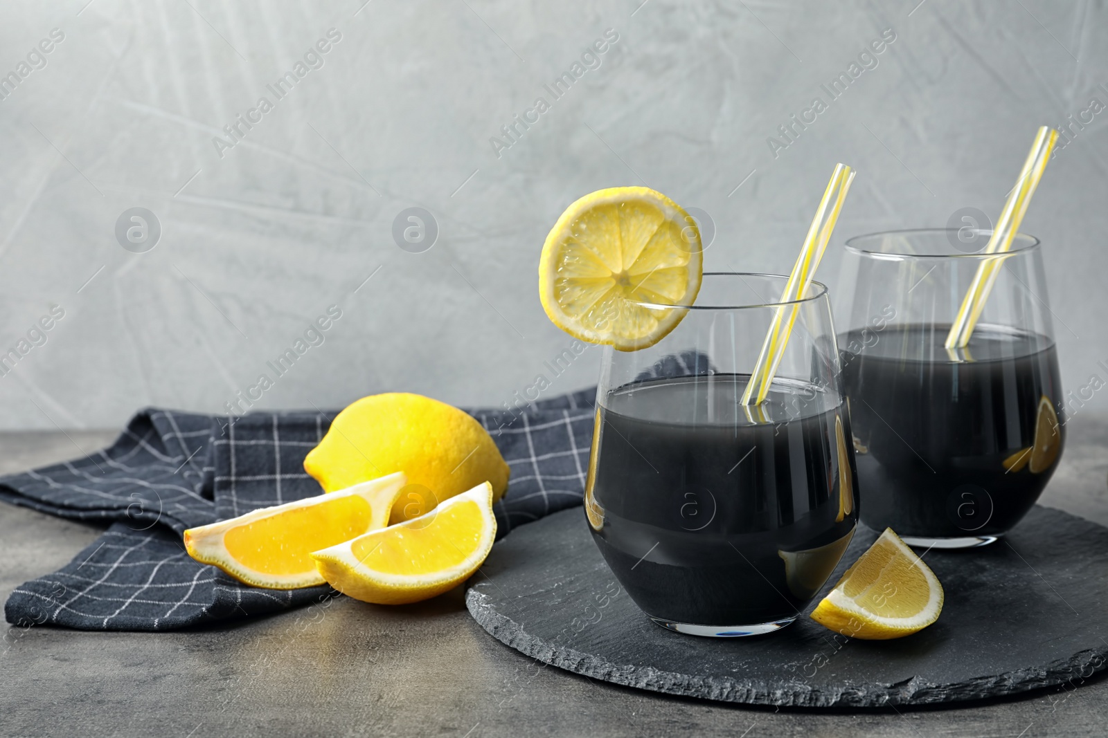 Photo of Glasses with natural black lemonade on table