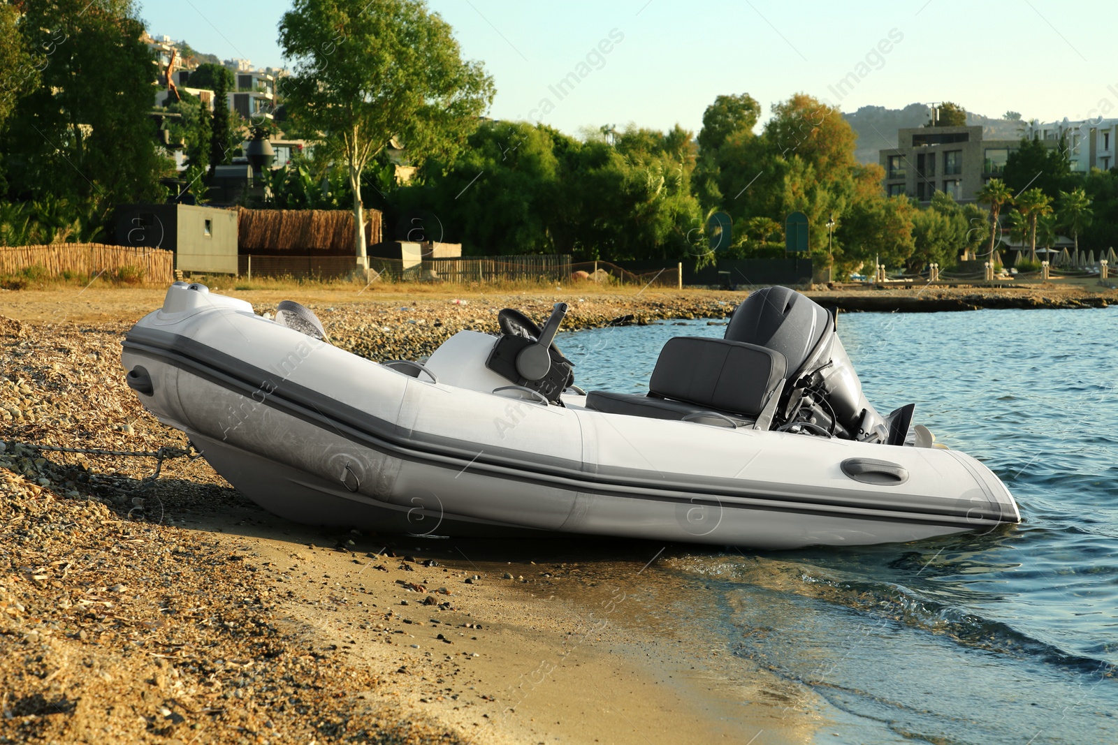 Photo of Beautiful view of resort and moored boat on seashore