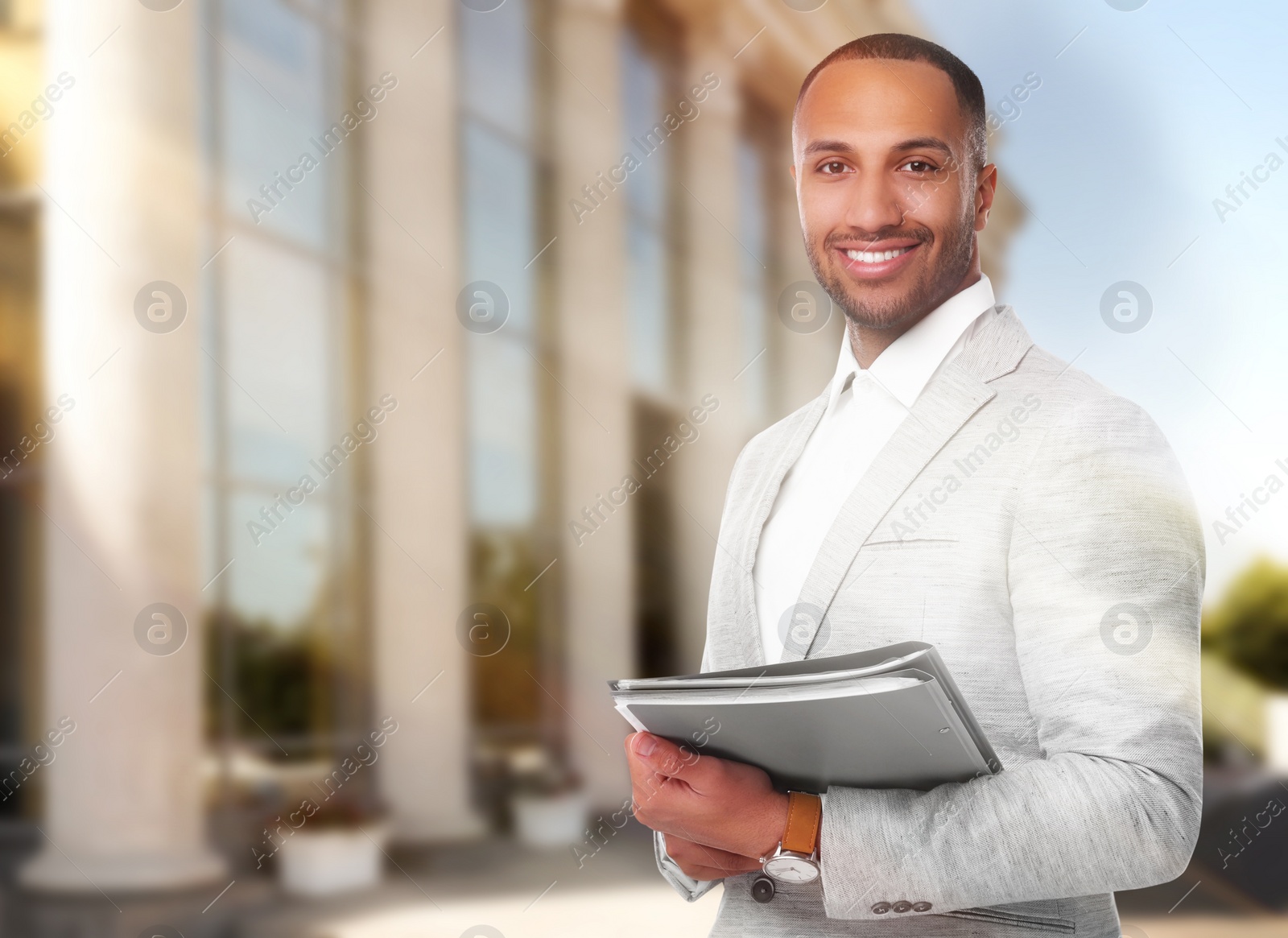 Image of Lawyer, consultant, business owner. Confident man with file folders smiling outdoors, space for text