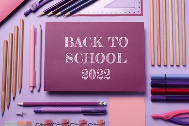 Image of Back to school 2022. Flat lay composition with different stationery on violet background