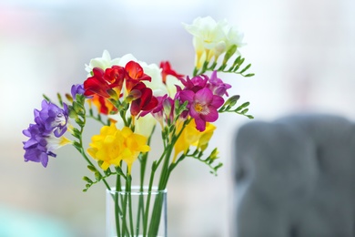 Beautiful bouquet with freesia flowers on blurred background