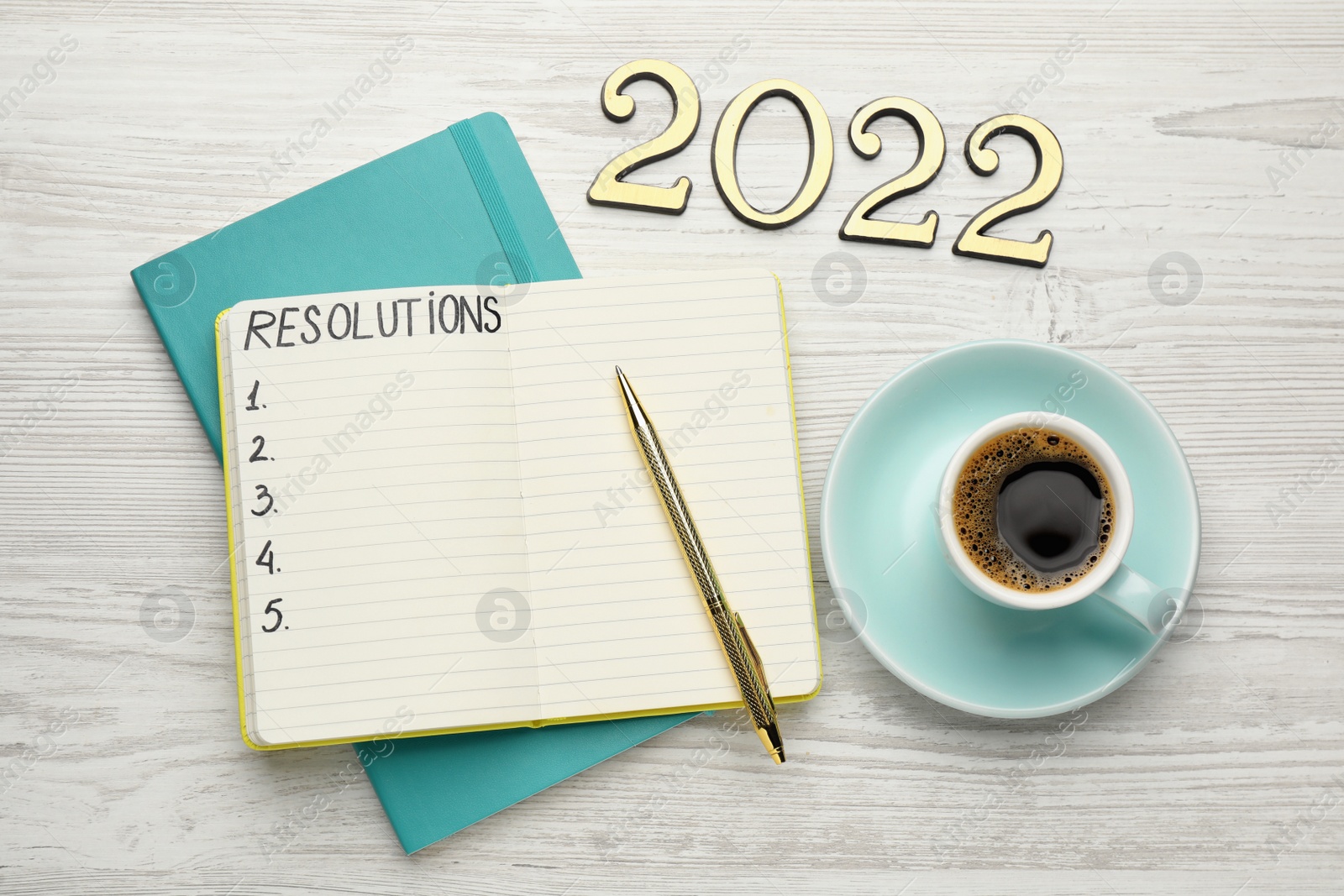 Photo of Making resolutions for 2022 new year. Flat lay composition with notebook on white wooden table