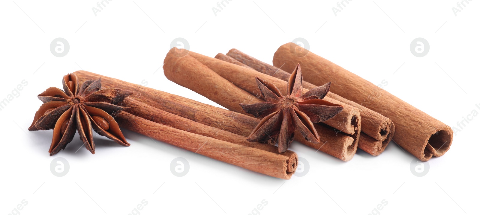 Photo of Aromatic cinnamon sticks and anise stars isolated on white