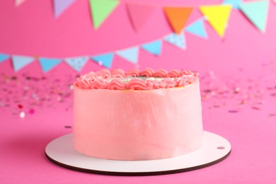 Photo of Cute bento cake with tasty cream and decor on pink background