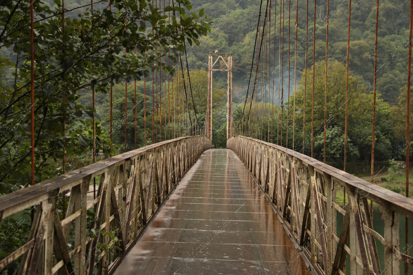 Photo of Beautiful view on rusty metal bridge over river in mountains