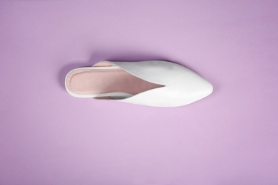 Female shoe on color background, top view