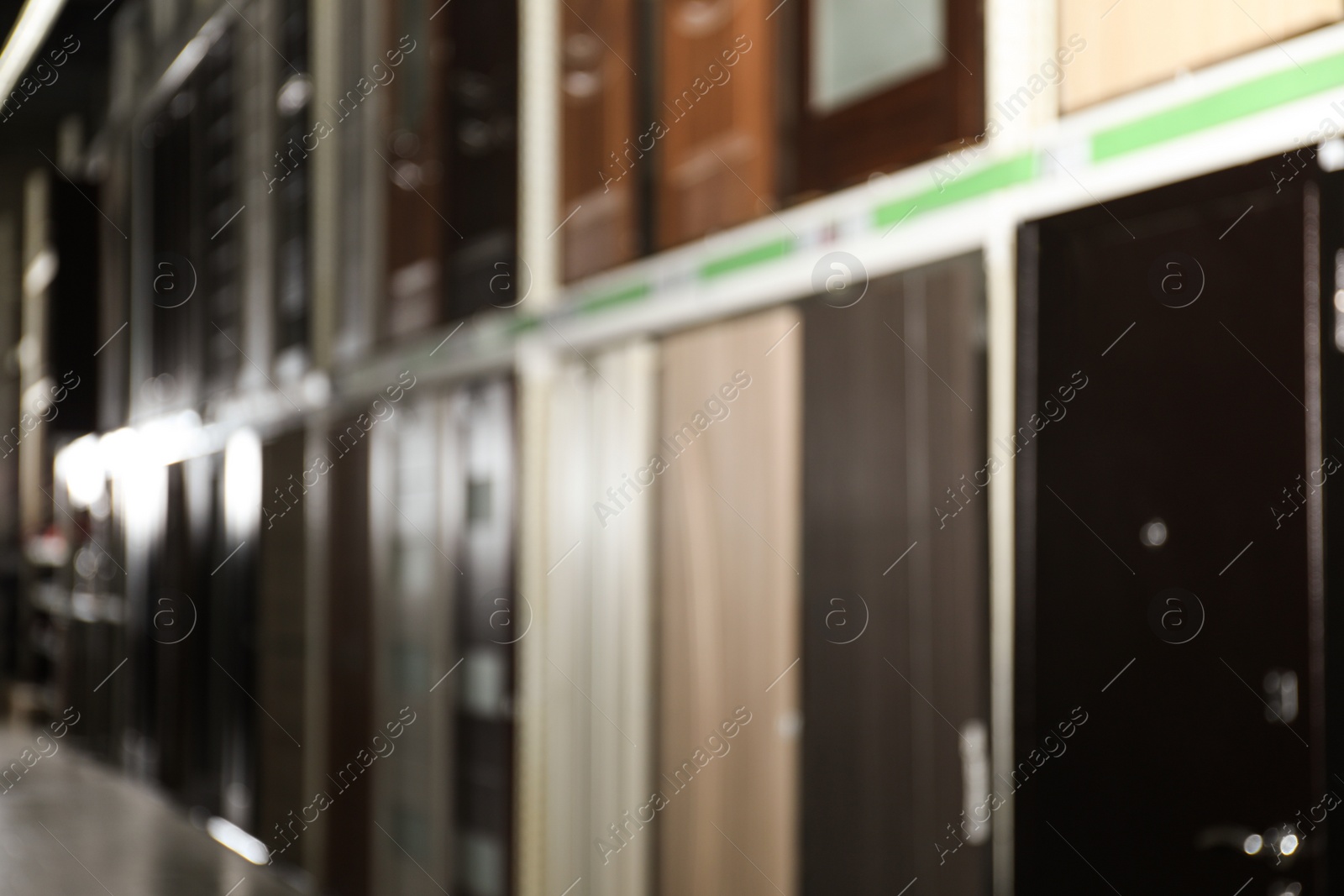 Photo of Blurred view of storage stands with building materials in wholesale warehouse