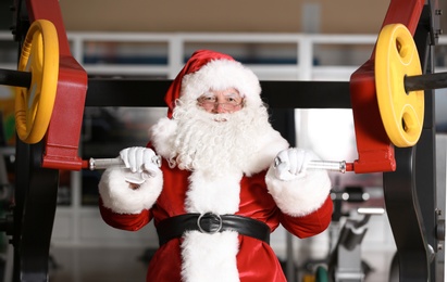 Photo of Authentic Santa Claus training in modern gym