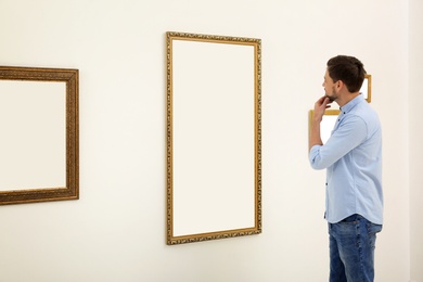 Man viewing exposition in modern art gallery