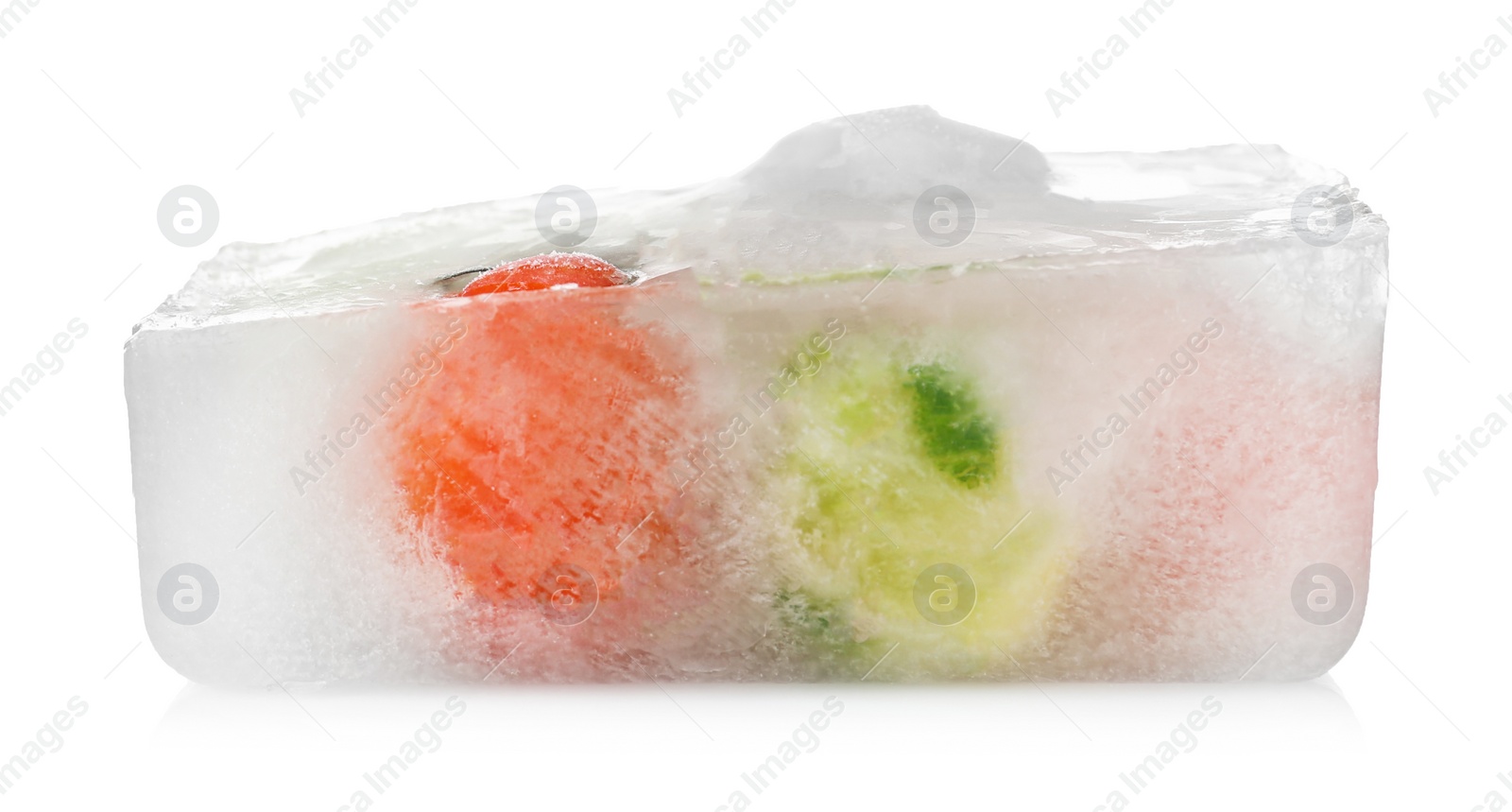 Photo of Fresh vegetables frozen in ice cube on white background