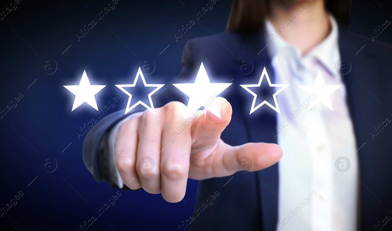 Image of Quality rating. Woman pointing at stars on virtual screen against dark background, closeup