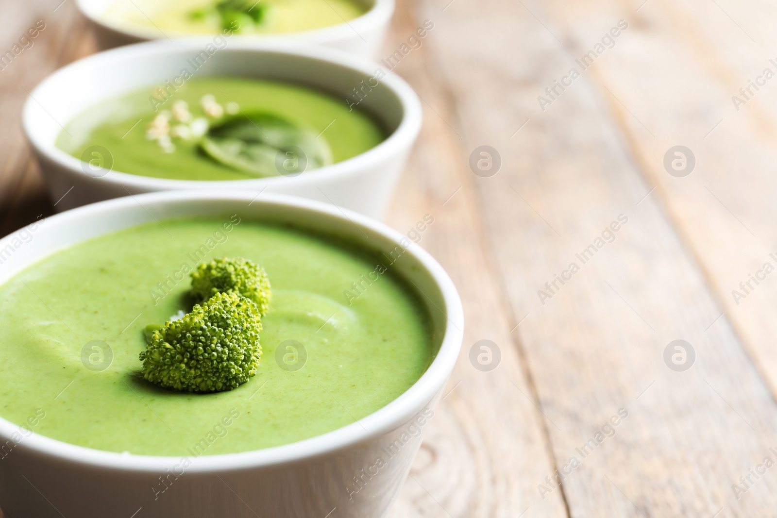 Photo of Fresh vegetable detox soup made of broccoli in dish on table, space for text