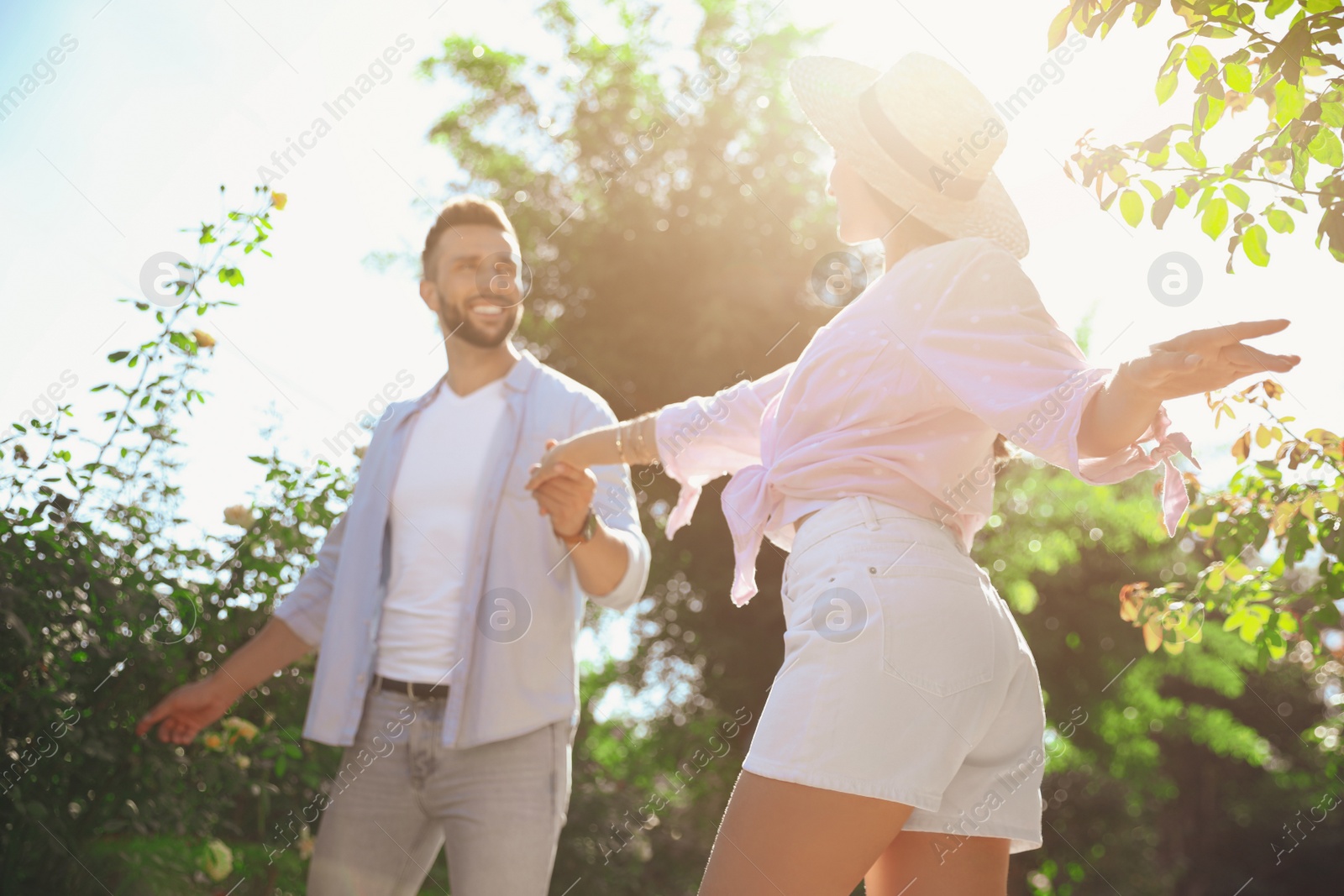 Photo of Lovely young couple dancing together in park on sunny day