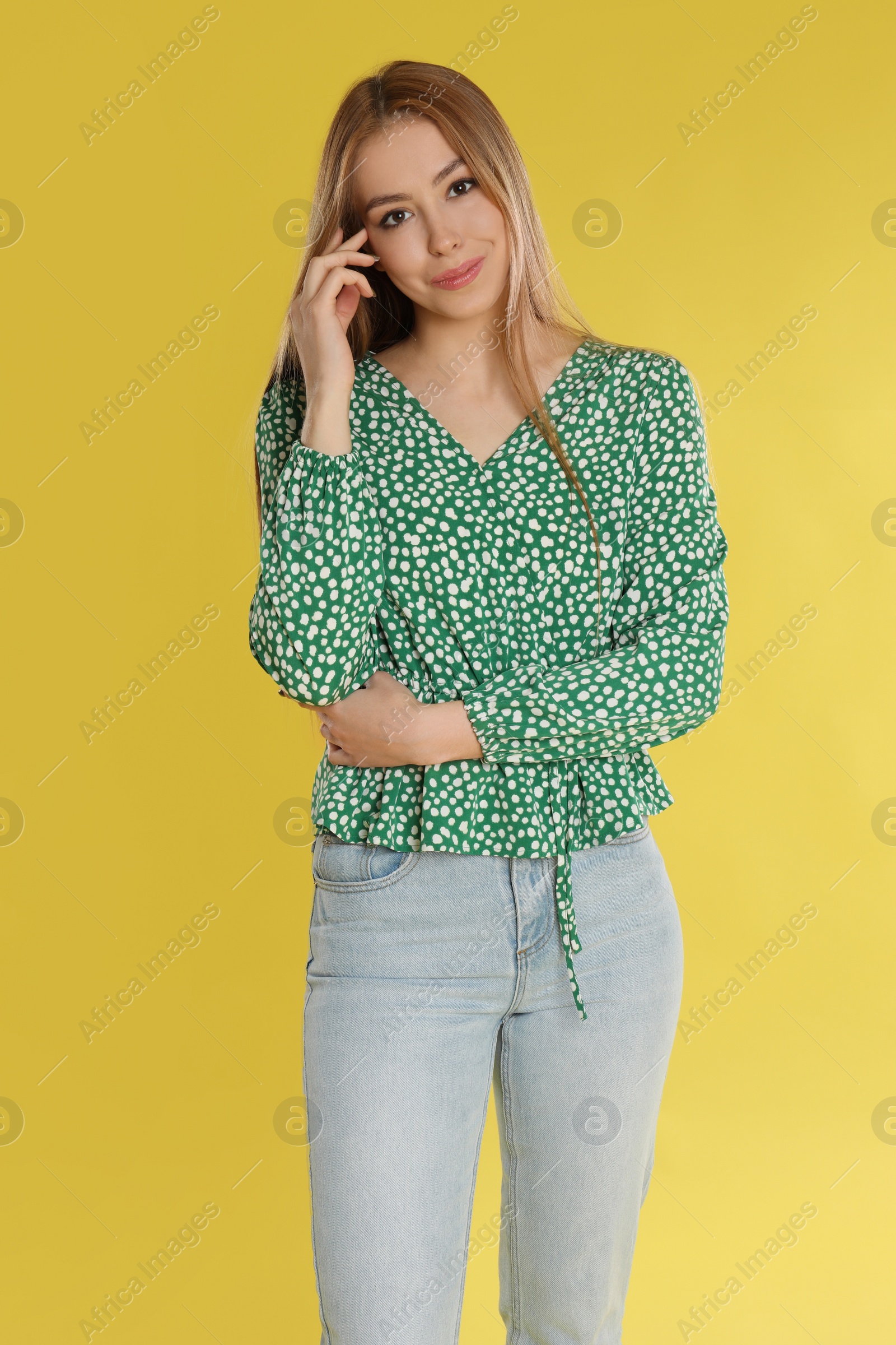 Photo of Teenage girl in casual outfit on yellow background