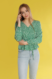 Photo of Teenage girl in casual outfit on yellow background