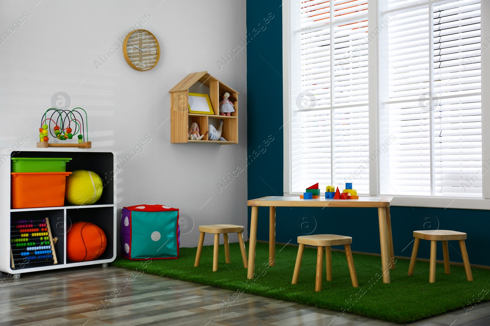 Photo of Stylish playroom interior with wooden table and stools