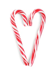 Photo of Heart made of Christmas candy canes on white background, top view