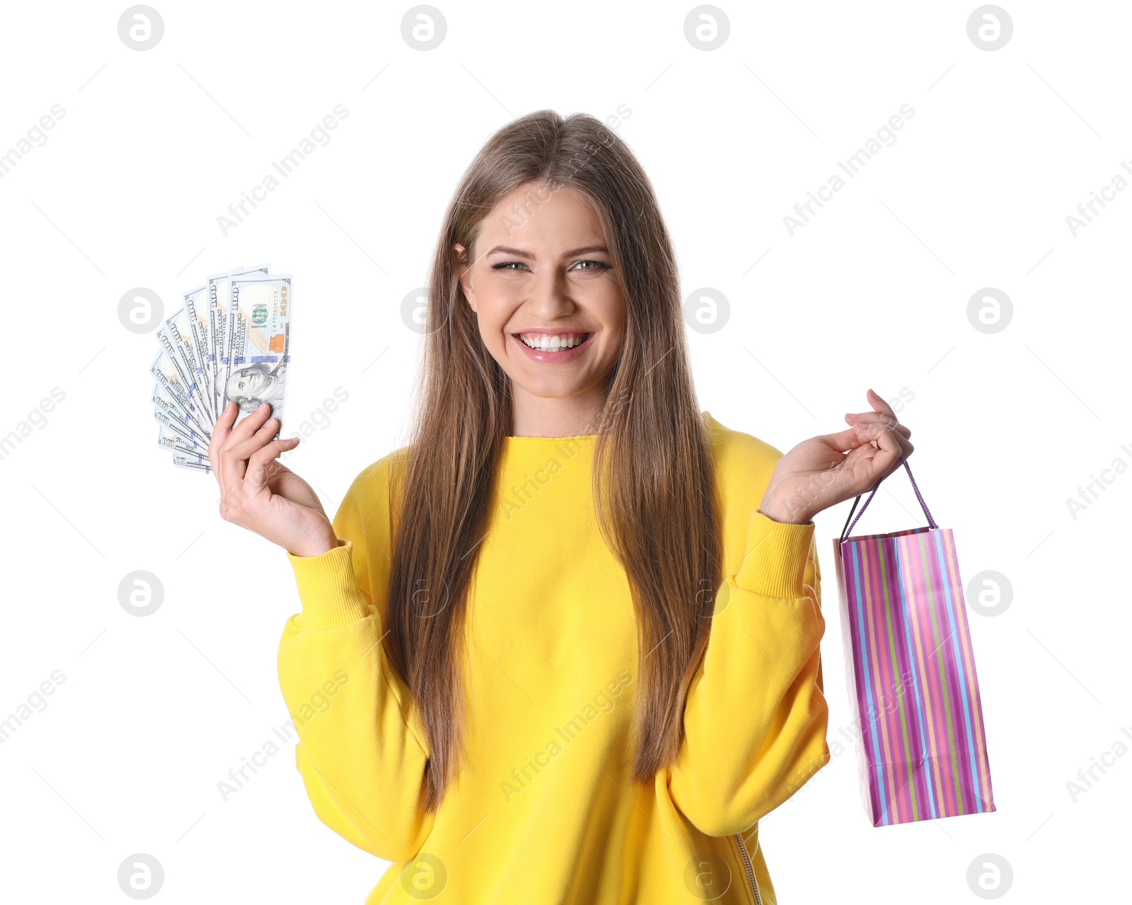 Photo of Portrait of happy young woman with money and shopping bag on white background