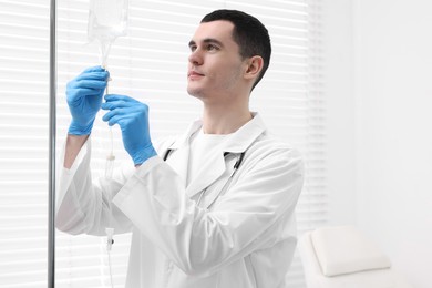 Photo of Doctor setting up IV drip in hospital