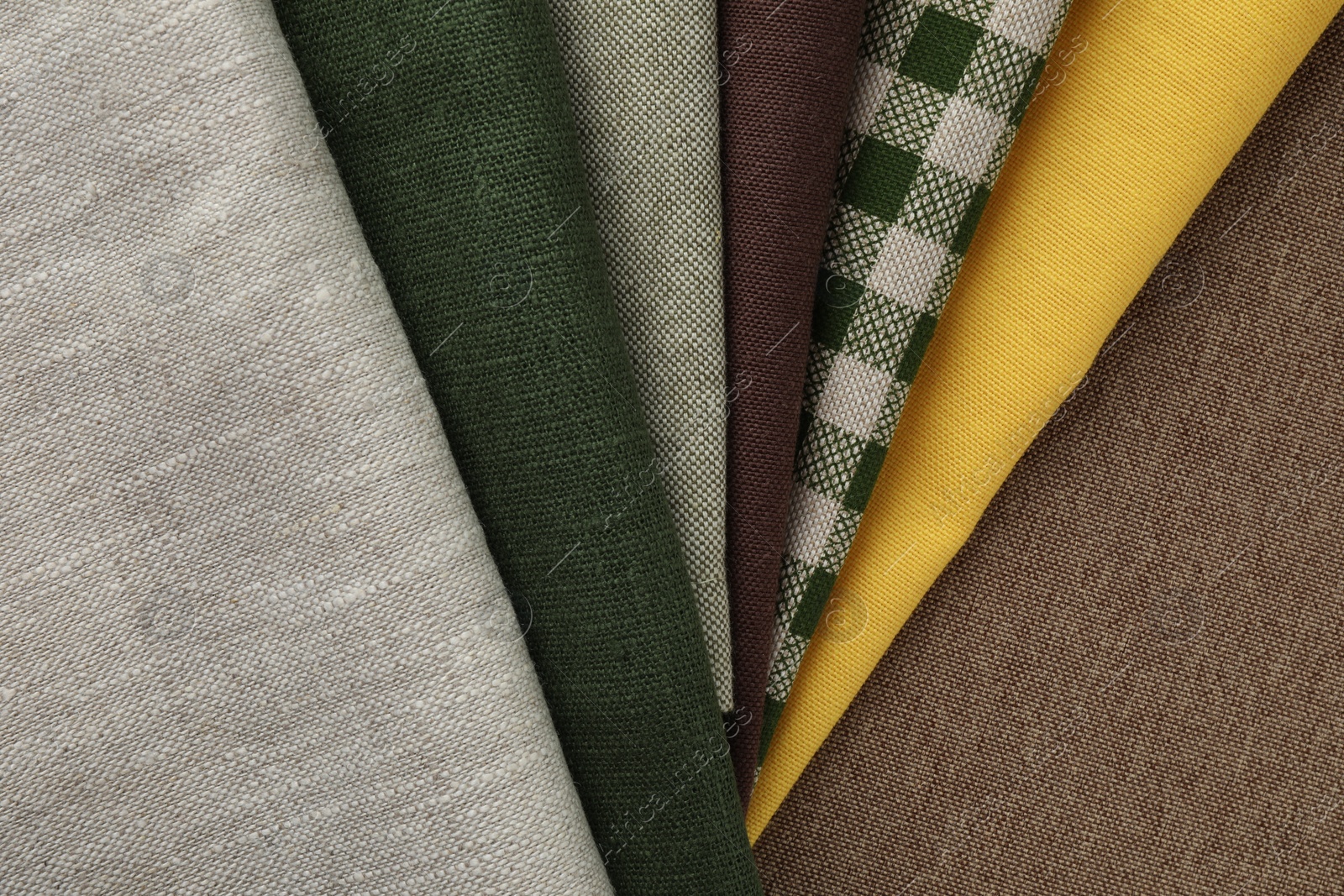 Photo of Many different fabrics on brown cloth, top view