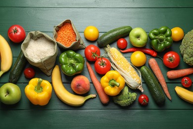 Photo of Fresh fruits, vegetables and seeds on green wooden table, flat lay