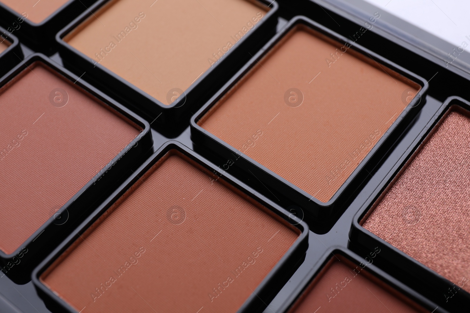 Photo of Colorful contouring palette as background, closeup. Professional cosmetic product