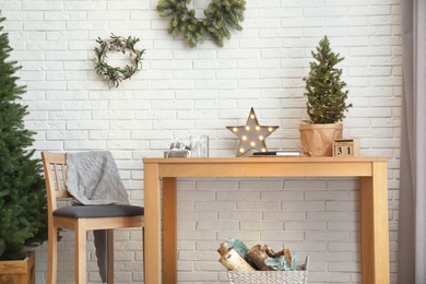 Photo of Wooden furniture with Christmas decor in room