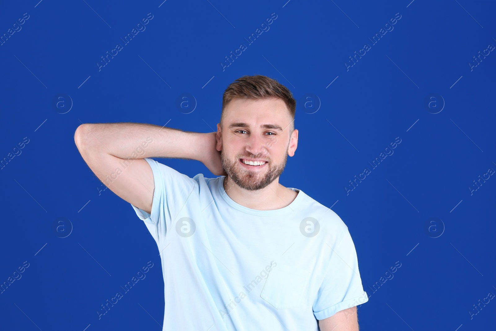 Photo of Portrait of handsome happy man on color background