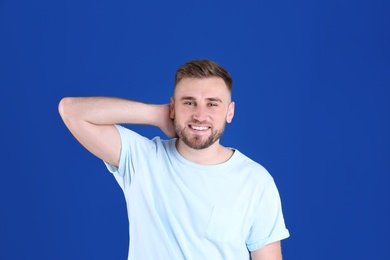 Portrait of handsome happy man on color background