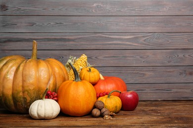 Happy Thanksgiving day. Beautiful composition with pumpkins on wooden table, space for text