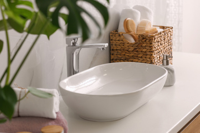 Photo of Stylish vessel sink on light countertop in modern bathroom