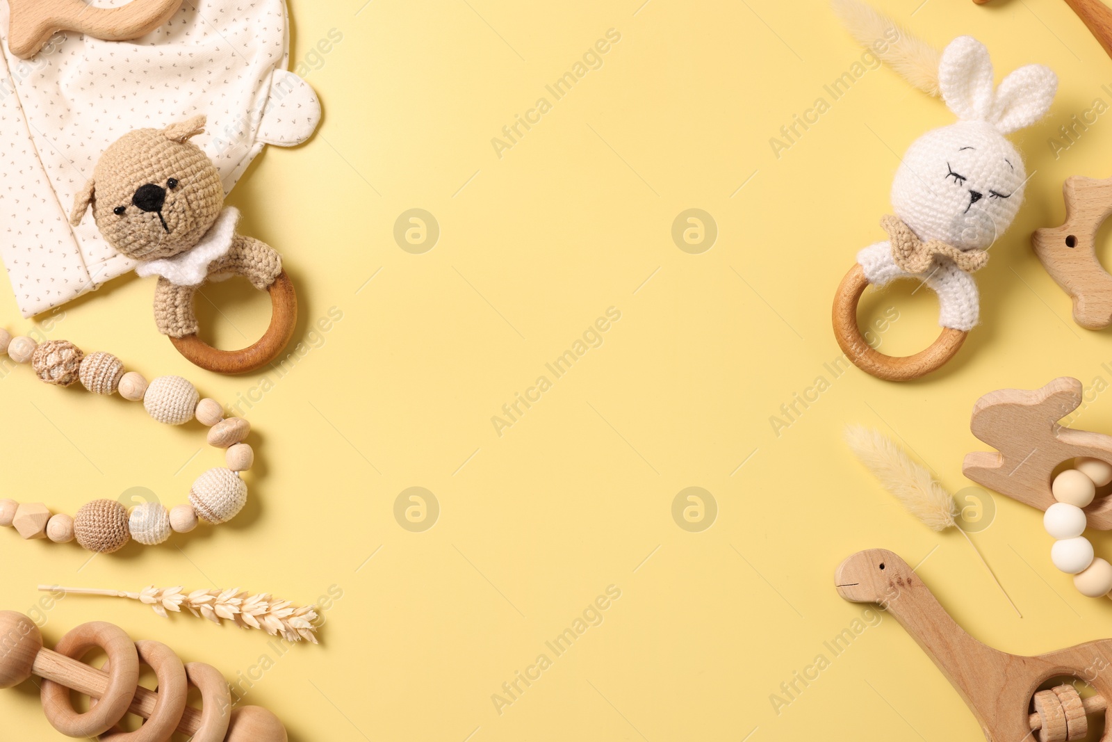 Photo of Different baby accessories on yellow background, flat lay. Space for text