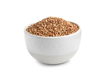 Bowl with uncooked buckwheat on white background