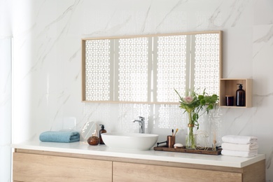 Modern bathroom interior with stylish mirror and vessel sink