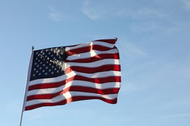 Photo of American flag fluttering outdoors on sunny day
