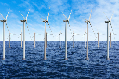 Image of Floating wind turbines installed in sea under blue sky. Alternative energy source 