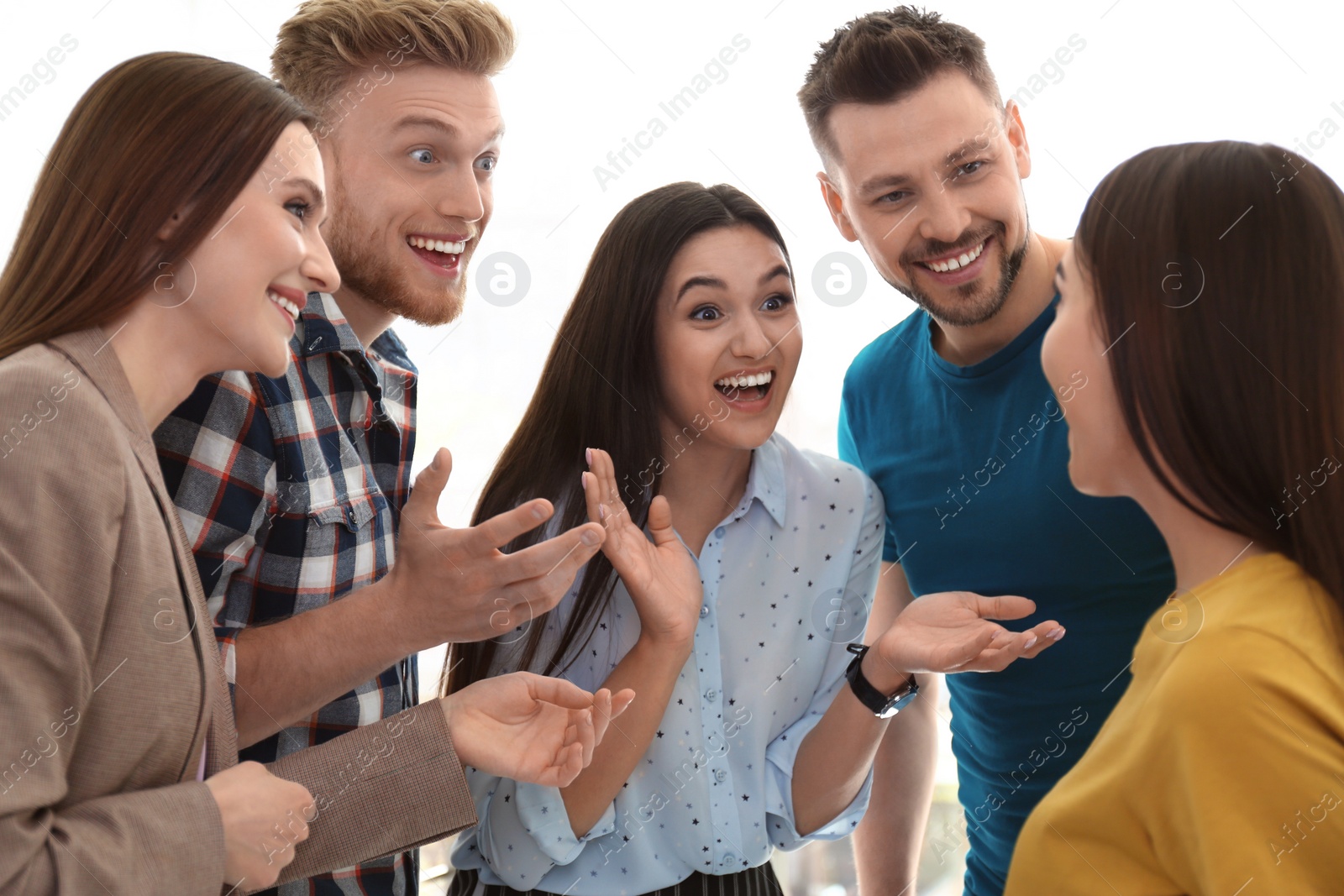 Photo of Group of happy people talking in light room