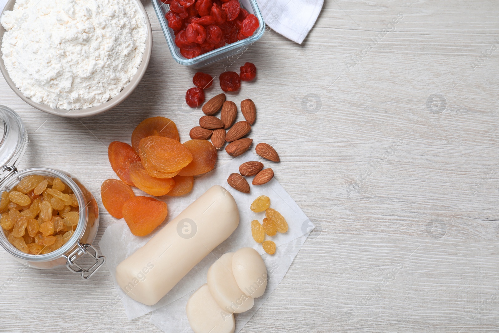 Photo of Ingredients for homemade Stollen on white wooden table, flat lay. Baking traditional German Christmas bread