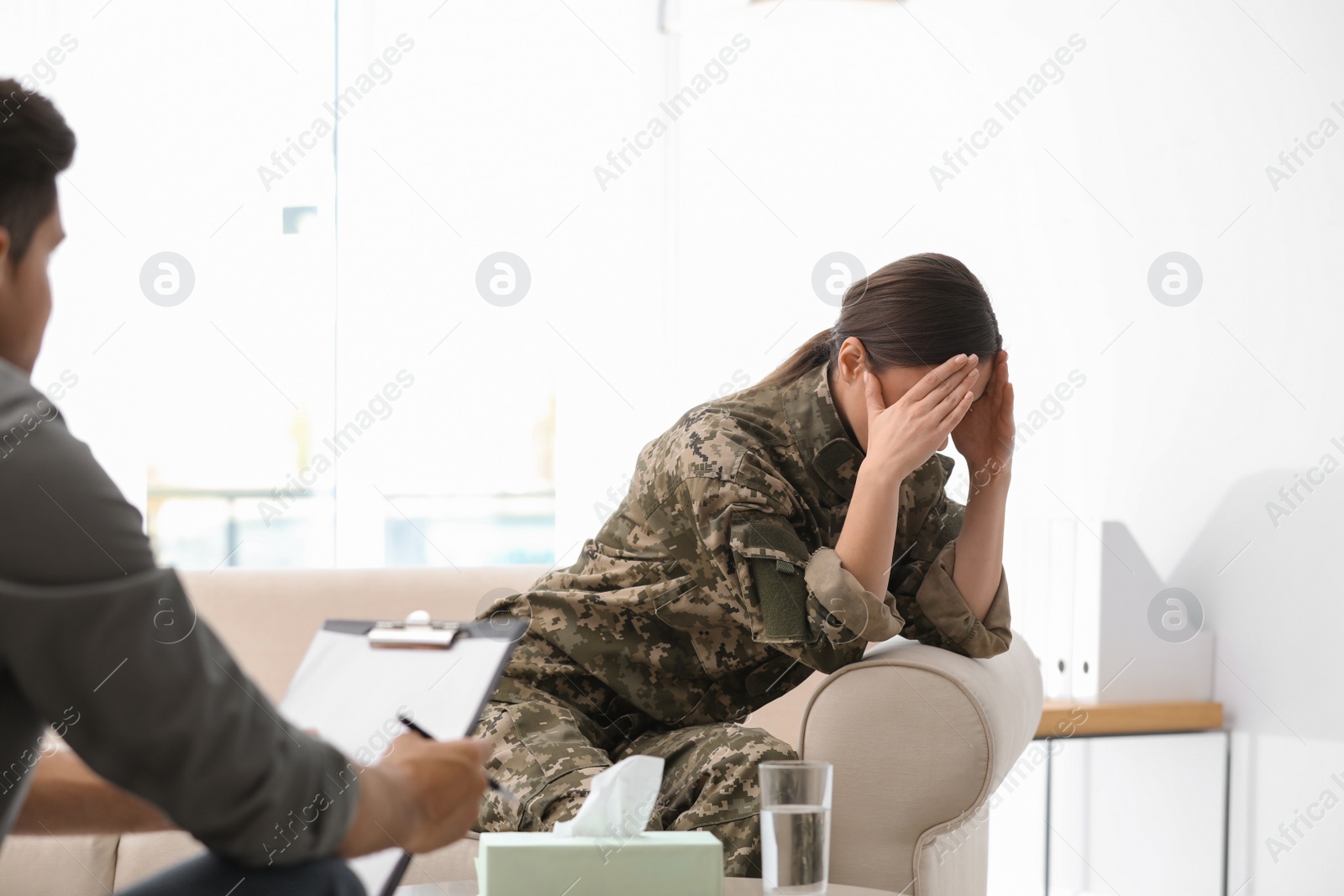 Photo of Psychotherapist working with female military officer in office