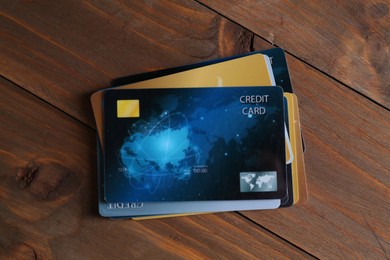 Photo of Many credit cards on wooden table, top view