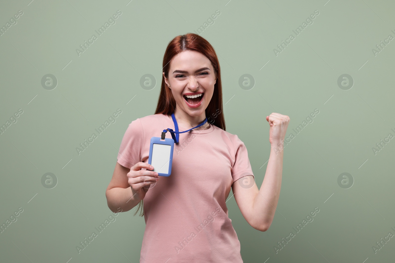 Photo of Emotional woman with vip pass badge on pale green background