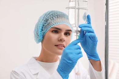 Photo of Nurse setting up IV drip in hospital